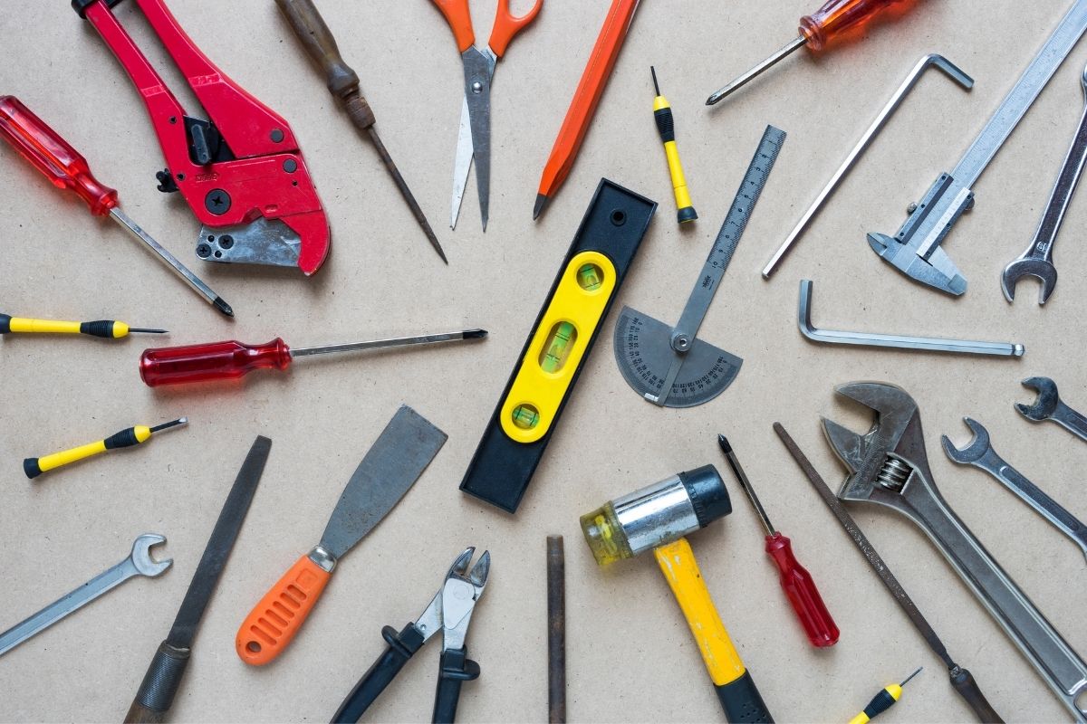 An assortment of tools displayed on a table, including wrenches, screwdrivers, and pliers, organized for easy access.